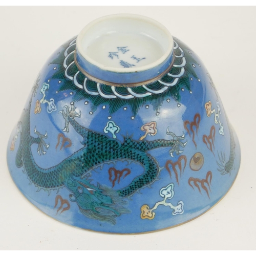 253 - A JAPANESE BLUE GLAZE PORCELAIN 'DRAGON' CUP
Having green enamel decoration of dragons chasing a fla... 