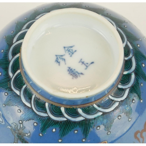 253 - A JAPANESE BLUE GLAZE PORCELAIN 'DRAGON' CUP
Having green enamel decoration of dragons chasing a fla... 