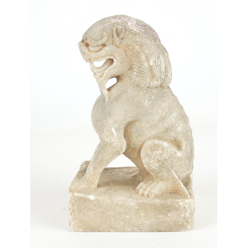 258 - A CHINESE CARVED STONE TEMPLE LION
Seated pose with grotesque features, on a square plinth.
(approx ... 