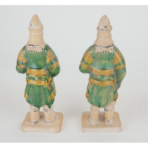 260 - A PAIR OF CHINESE SANCAI GLAZED POTTERY WARRIOR FIGURES
Standing pose, clutching a dragon mask shiel... 