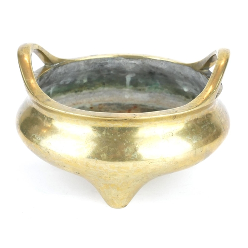 261 - A CHINESE BRONZE TWIN HANDLED TRIPOD CENSER
Having loop handles and tripod feet, bearing a Xuande 14... 