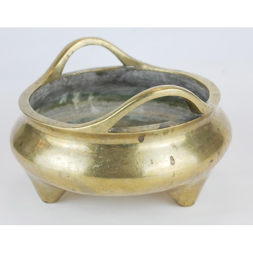 261 - A CHINESE BRONZE TWIN HANDLED TRIPOD CENSER
Having loop handles and tripod feet, bearing a Xuande 14... 