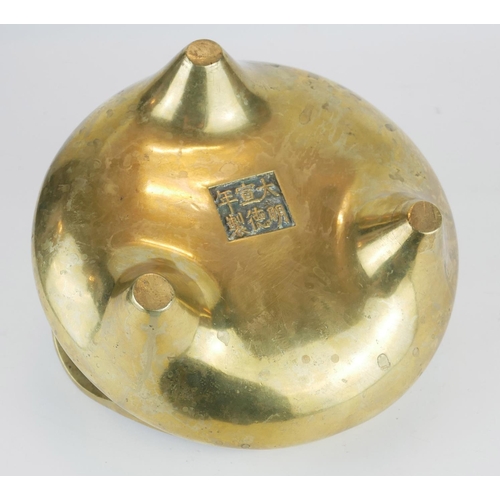 261 - A CHINESE BRONZE TWIN HANDLED TRIPOD CENSER
Having loop handles and tripod feet, bearing a Xuande 14... 
