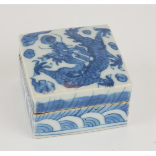 266 - A CHINESE BLUE AND WHITE PORCELAIN SQUARE TRINKET BOX
Painted decoration, dragon chasing a flaming p... 