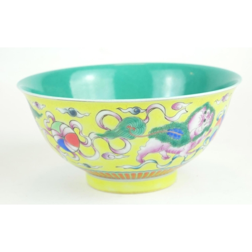 271 - A CHINESE YELLOW GLAZE PORCELAIN 'DOGS OF FO' BOWL
Hand painted with a pair of temple dogs chasing a... 