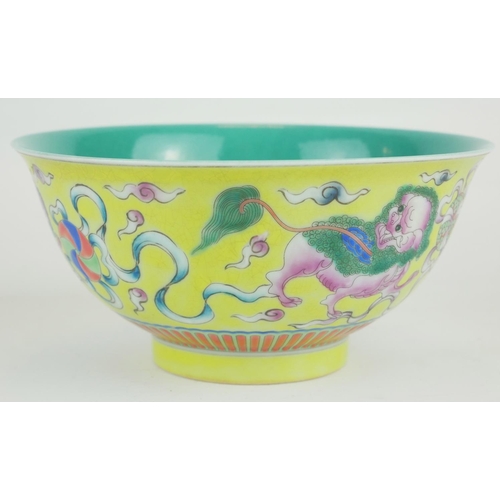 271 - A CHINESE YELLOW GLAZE PORCELAIN 'DOGS OF FO' BOWL
Hand painted with a pair of temple dogs chasing a... 