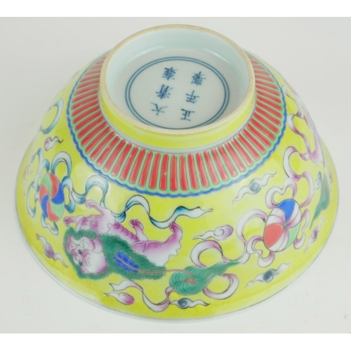 271 - A CHINESE YELLOW GLAZE PORCELAIN 'DOGS OF FO' BOWL
Hand painted with a pair of temple dogs chasing a... 