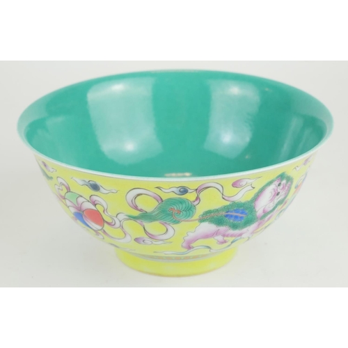 271 - A CHINESE YELLOW GLAZE PORCELAIN 'DOGS OF FO' BOWL
Hand painted with a pair of temple dogs chasing a... 