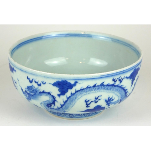277 - A CHINESE BLUE AND WHITE PORCELAIN 'FIVE TOE DRAGON' BOWL
Decorated with dragons chasing a flaming p... 