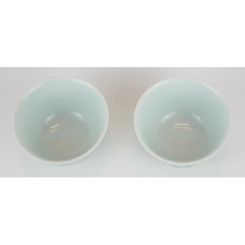 295 - A PAIR OF CHINESE CELEDON GLAZE 'BAT' CUPS
Having hand painted underglaze blue bats and square mark ... 
