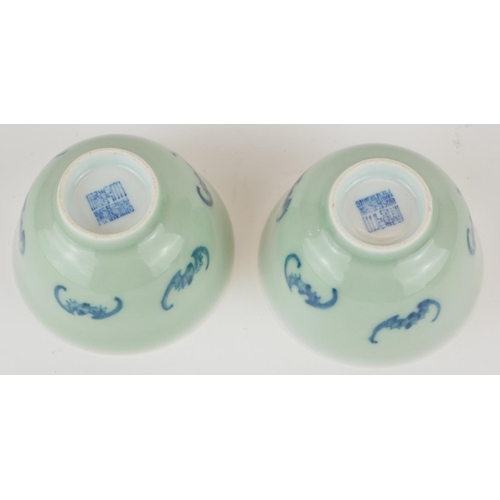 295 - A PAIR OF CHINESE CELEDON GLAZE 'BAT' CUPS
Having hand painted underglaze blue bats and square mark ... 