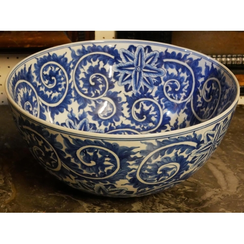 245a - A LARGE ORIENTAL BLUE AND WHITE PORCELAIN BOWL
Having an underglaze blue decoration of scrolled and ... 