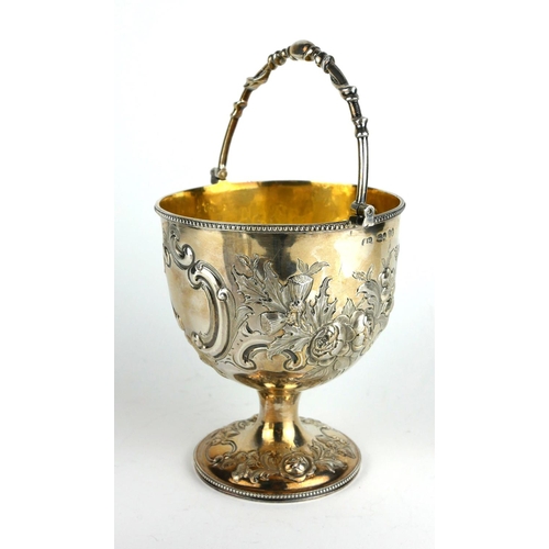 282 - A VICTORIAN SILVER BONBON BASKET
Having a swing handle with embossed floral decoration and gilt inte... 