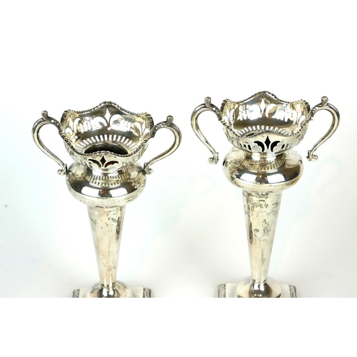 297A - A PAIR OF EARLY 20TH CENTURY SILVER FLOWER VASES
Having twin handles and pierced decoration on squar... 