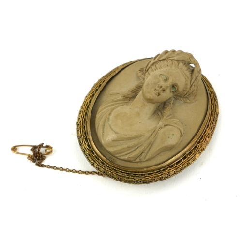 304a - A 19TH CENTURY ITALIAN LAVA CAMEO
The oval classical portrait carved in high relief, in a gold plate... 