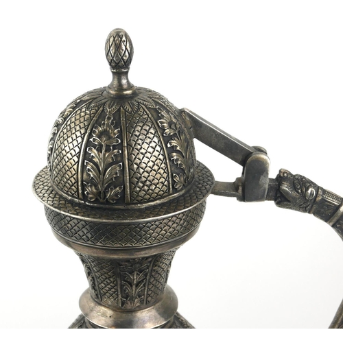 344 - A LARGE PERSIAN WHITE METAL TEAPOT
Having a dome form lid with lion mask handle and fine embossed fl... 