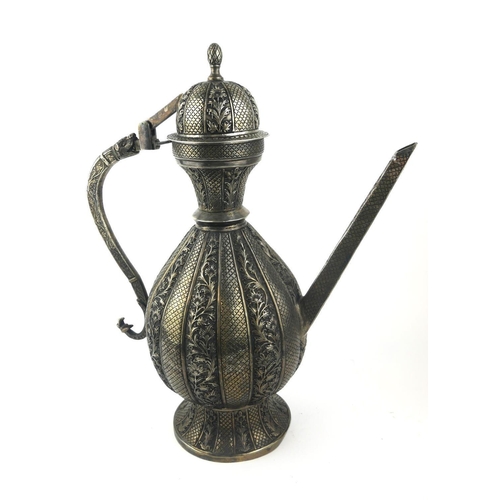 344 - A LARGE PERSIAN WHITE METAL TEAPOT
Having a dome form lid with lion mask handle and fine embossed fl... 