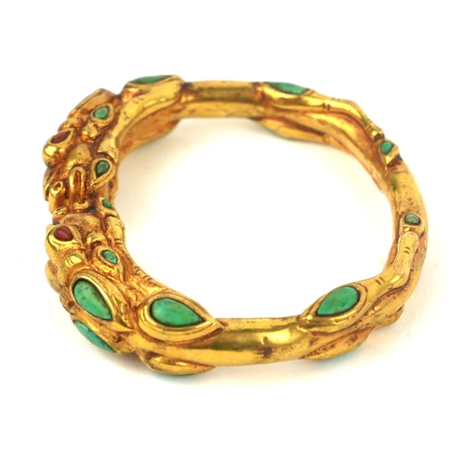 348 - A TIBETAN YELLOW METAL AND TURQUOISE DRAGON BANGLE
Having to opposing dragons with cabochon cut ston... 