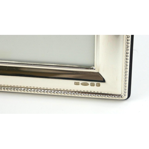 350 - A PAIR OF MODERN SILVER RECTANGULAR PHOTOGRAPH FRAMES
With beaded edges, marked ‘VS .925 Birmingham ... 