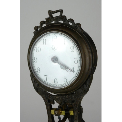 402A - A BRONZE FIGURAL MYSTERY CLOCK IN THE FORM OF AN EARLY AIRMAN.
(38cm)

Condition: good