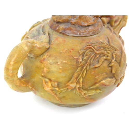 413 - AN EARLY QING DYNASTY CHINESE SOAPSTONE DRAGON TEAPOT AND COVER
The ovoid body with delicate spout a... 