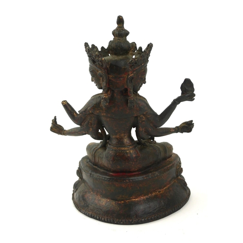 417 - A TIBETAN GILT BRONZE THREE HEAD SADGSDGG BUDDHA FIGURE
Having three heads and eight arms, on a doub... 