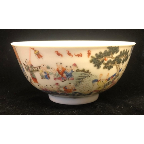 425A - A CHINESE FAMILLE ROSE THOUSAND BOYS DECORATED BOWL, bearing a Qing dynasty mark. Diameter 11.4 x H ... 