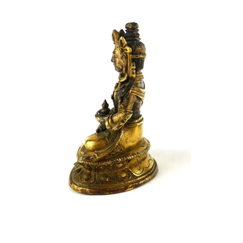 430 - A LATE 18TH/EARLY 19TH CENTURY CHINESE GILT BRONZE FIGURE OF GUANYIN
Seated pose clutching a vessel,... 