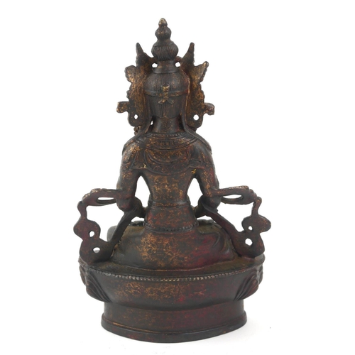 432 - A TIBETAN GILT BRONZE LAKSHMI BUDDHA FIGURE 
Seated pose with elaborate headdress, on a lotus base.
... 