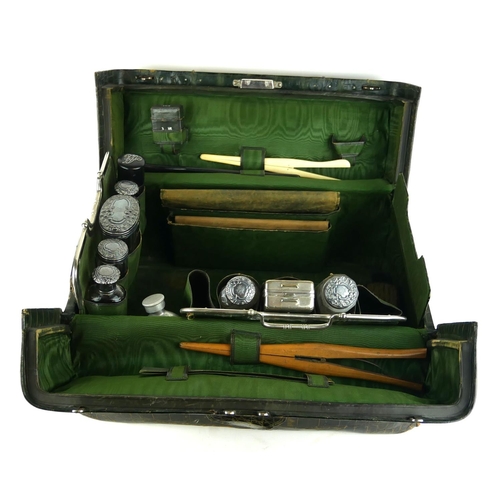 460 - A LATE 19TH CENTURY DOCTORS FAUX CROCODILE SKIN GLADSTONE BAG
With contents including silver topped ... 