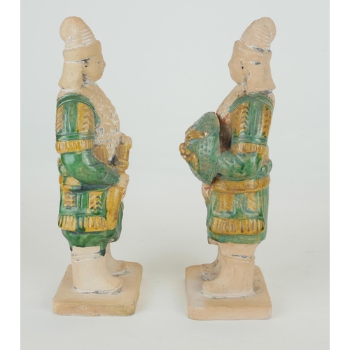 470 - A PAIR OF CHINESE SANCAI GLAZED POTTERY WARRIOR FIGURES
Standing pose, clutching a dragon mask shiel... 