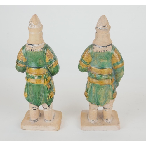 470 - A PAIR OF CHINESE SANCAI GLAZED POTTERY WARRIOR FIGURES
Standing pose, clutching a dragon mask shiel... 