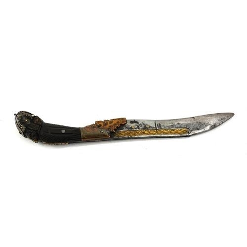 473 - A 19TH CENTURY INDO-PERSIAN HORN AND STEEL PESH KABS DAGGER
Having a carved handle with gilt metal m... 