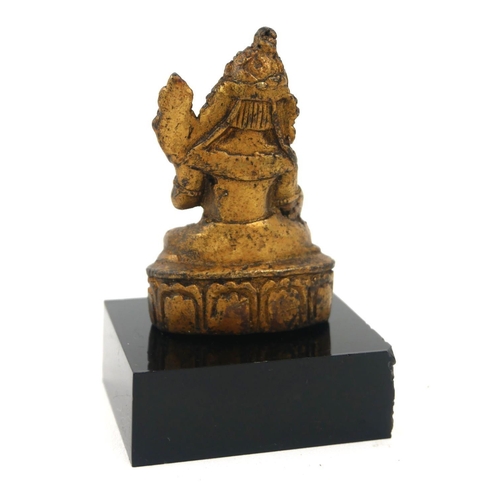 496 - A CHINESE GILT BRONZE BUDDHA
Seated pose holding a single flower on lotus base, on black perspex bas... 