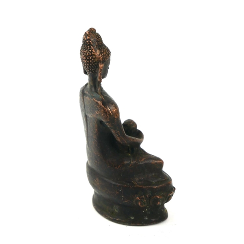 498 - A CHINESE BRONZE BUDDHA
Seated pose holding a bowlon lotus base. 
(approx 9cm)