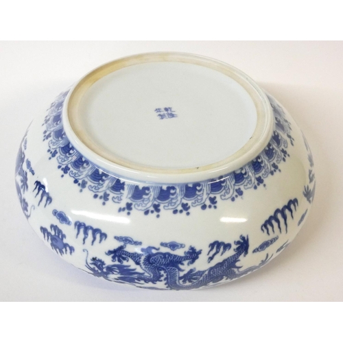 520 - A CHINESE BLUE AND WHITE PORCELAIN DRAGON BOWL
Decorated with opposing dragons chasing a flaming pea... 