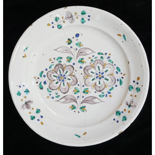 523 - AN 18TH CENTURY FAIENCE POTTERY CHARGER/DISH
Hand painted floral decoration. 
(approx 30cm)