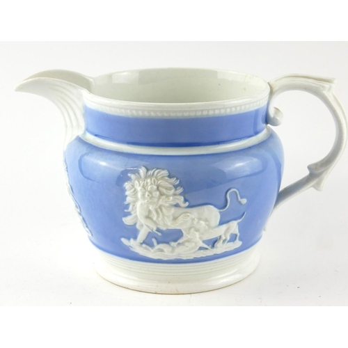 526 - AN EARLY 19TH CENTURY STONEWARE POTTERY JUG
Having applied Royal Coat of Arms and lion figures on li... 