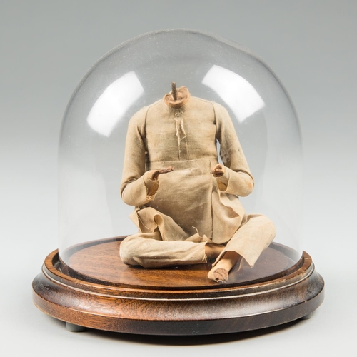 528 - A 19TH CENTURY INDIAN CLAY FIGURE UNDER GLASS DOME. Reputed to be unfired to protect the soul of the... 