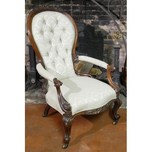 838 - A HIGH VICTORIAN MAHOGANY SPOONBACK OPEN ARMCHAIR
Carved with florets, scroll arms, on cabriole legs... 