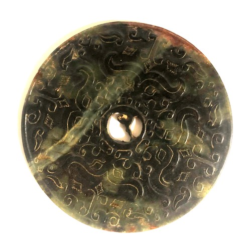 511a - A CHINESE GREEN JADE BI
Carved with dragons and beasts.
(diameter 15cm)