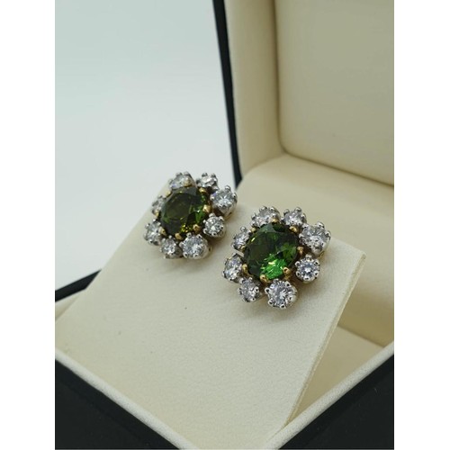 313A - A PAIR OF 18CT WHITE GOLD EARRINGS
of floral form, set with central green sapphires surrounded by di... 