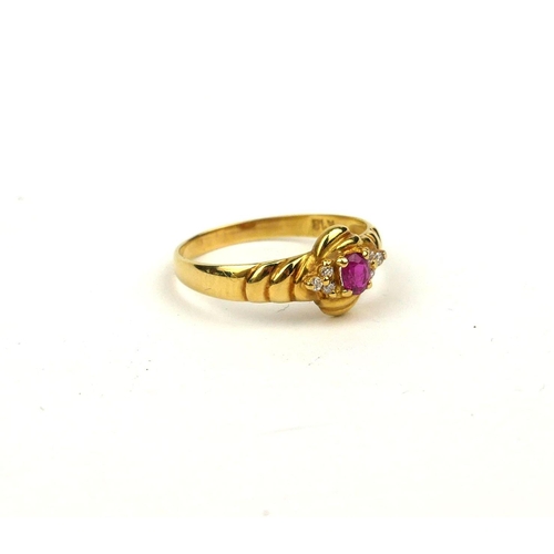 120a - AN 18CT GOLD, RUBY AND DIAMOND RING
The oval cut ruby flanked by diamonds in a twist design (size J/... 