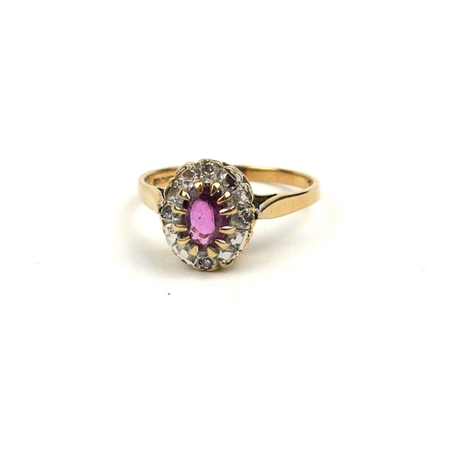 121a - A VINTAGE 9CT GOLD, RUBY AND DIAMOND RING
The oval cut ruby edged with round cut diamonds (size J/K)... 
