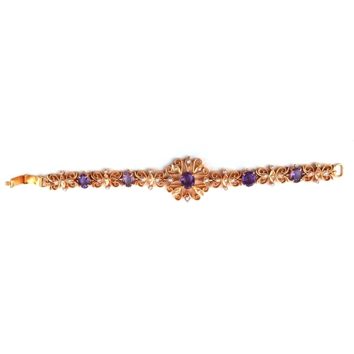 126a - A 22CT GOLD, AMETHYST AND SEED PEARL BRACELET
Having a central oval cut amethyst in a pierced frame,... 