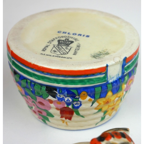 226 - CLARICE CLIFF, BIZARRE RANGE, A SMALL BEEHIVE HONEY POT AND COVER
In ‘Gayday Pattern’, painted in co... 