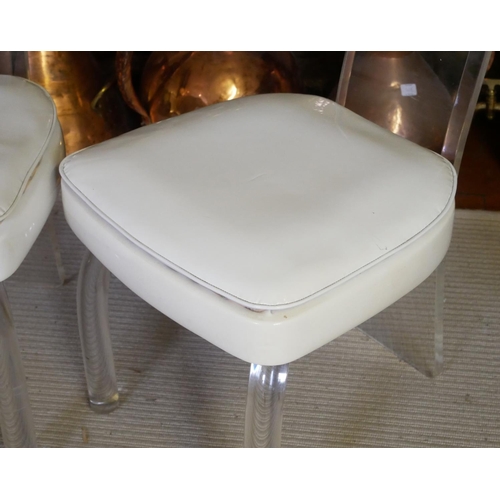 662 - A PAIR OF VINTAGE AMERICAN LUCIDE AND FAUX CREAM LEATHER CHAIRS
With bevelled lucite backs raised on... 