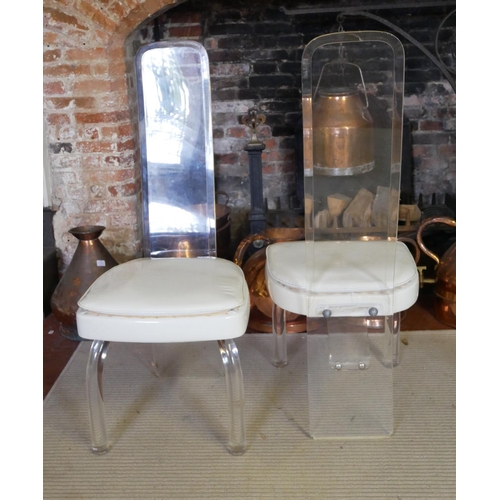 662 - A PAIR OF VINTAGE AMERICAN LUCIDE AND FAUX CREAM LEATHER CHAIRS
With bevelled lucite backs raised on... 