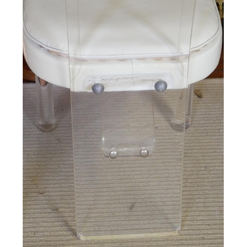 662 - A PAIR OF VINTAGE AMERICAN LUCIDE AND FAUX CREAM LEATHER CHAIRS
With bevelled lucite backs raised on... 