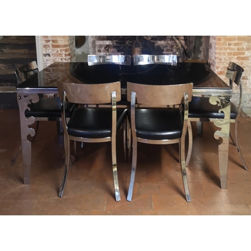 669 - A POLISHED CHROME DINING SUITE
Comprising a black glass top table and six black faux leather upholst... 